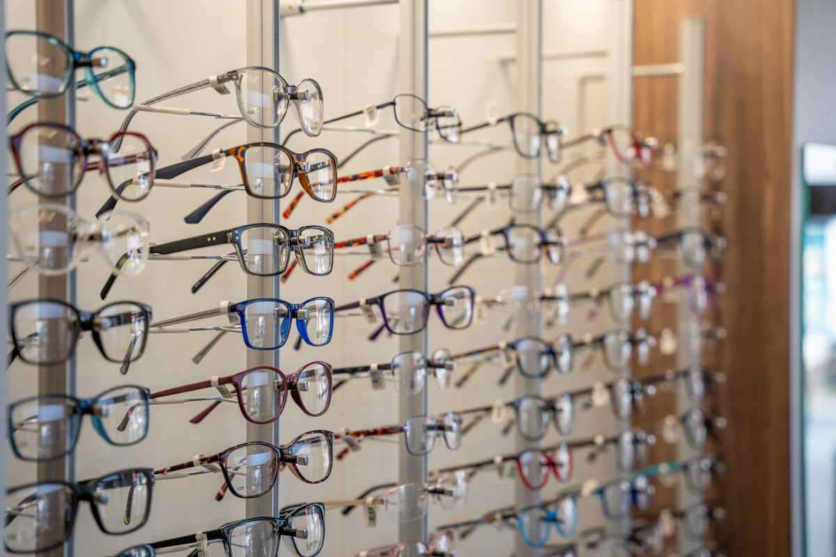 Eyeglass display with rows of various prescription and fashion frames on stands