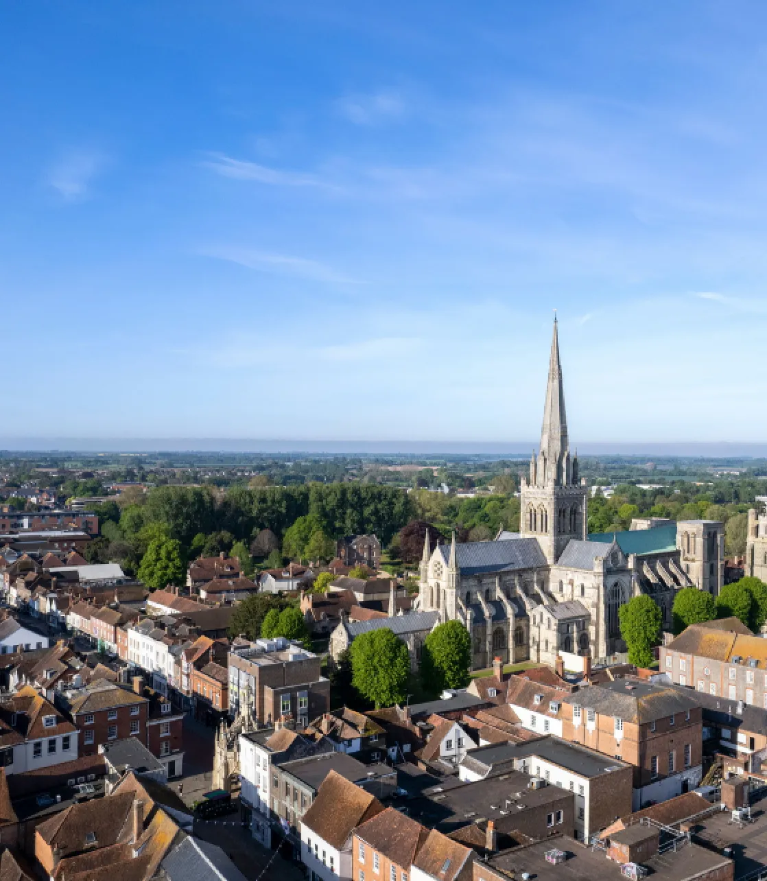 Image of Chichester city, featuring a beautiful church and town houses.