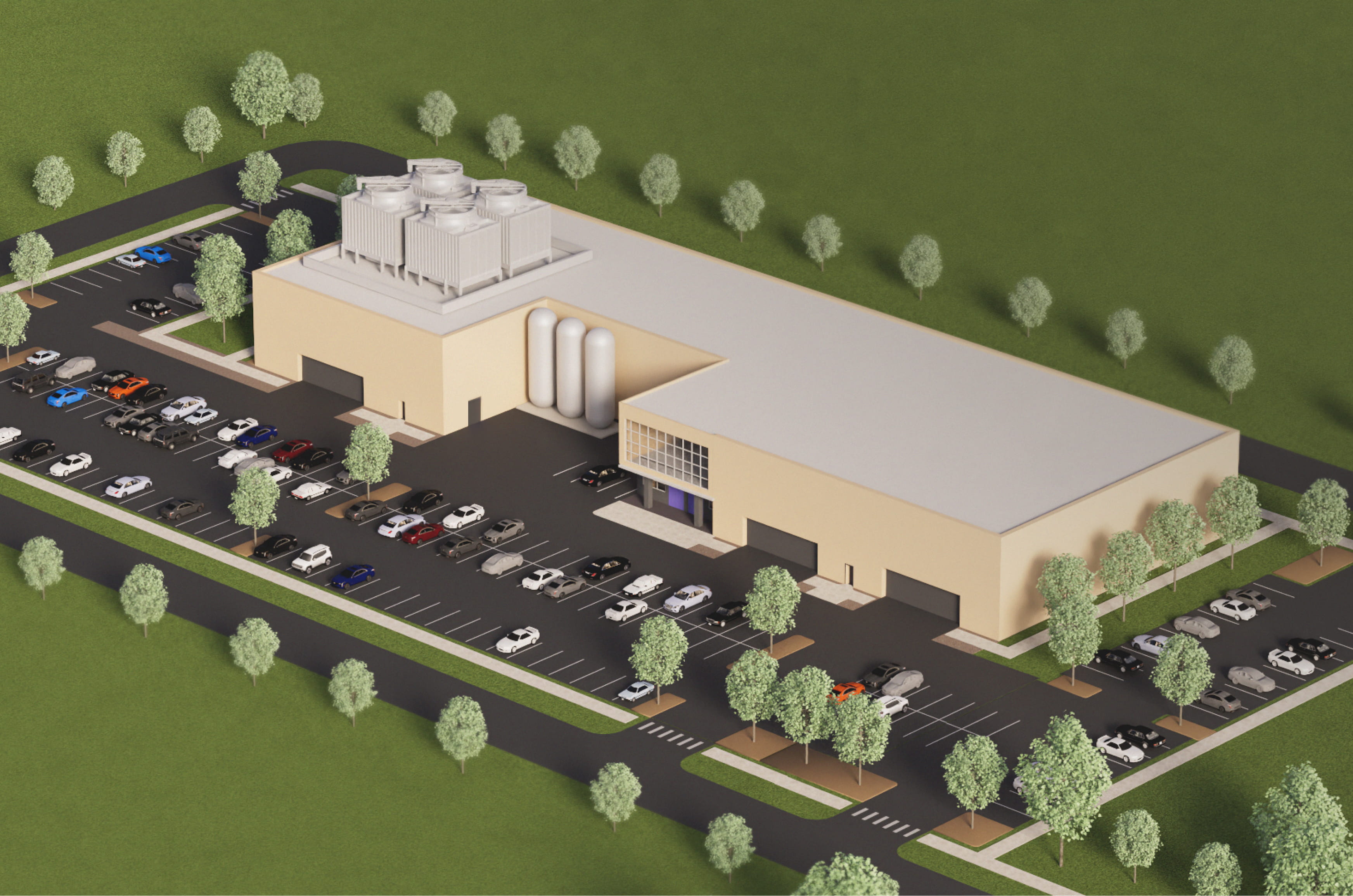 Aerial view of a large beige industrial building with rooftop cooling units, surrounded by a parking lot with many cars and green trees.