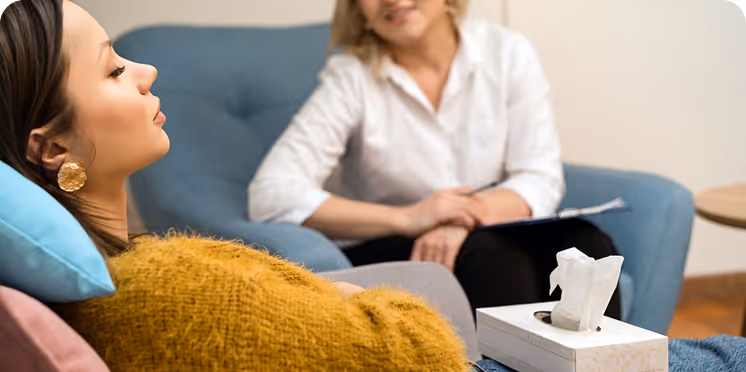A woman in a yellow sweater in therapy