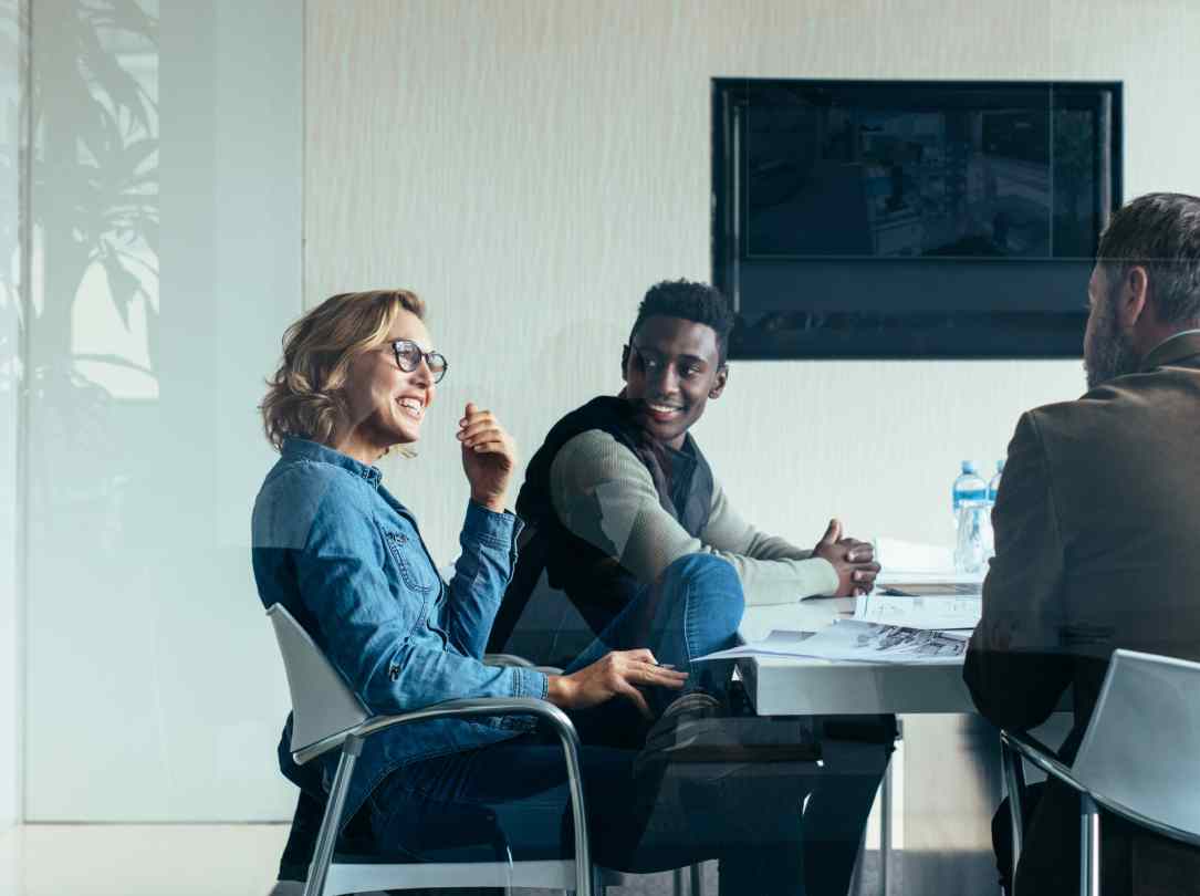 A CFO talks with her team in a conference room about financial objectives.