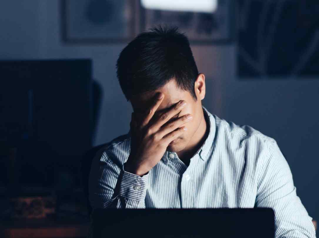 Frustrated merchant with his hand on his face in disappointment.