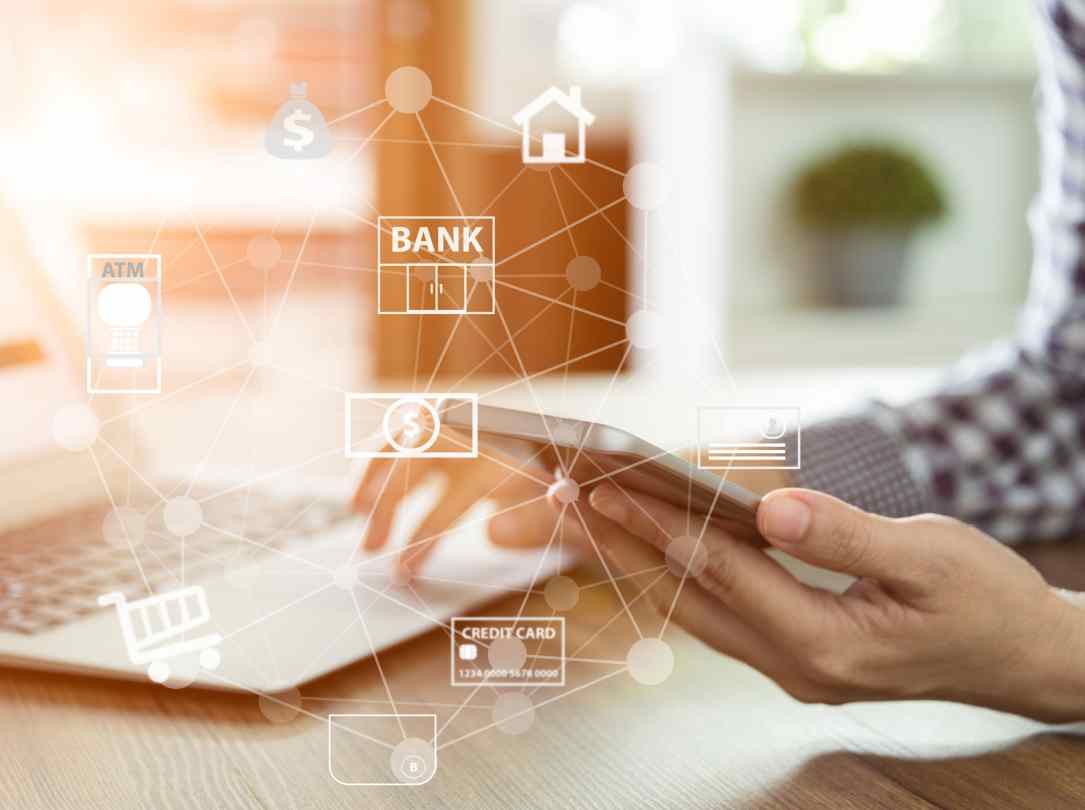 A web of icons showing the open banking ecosystem in front of a man holding his smartphone.