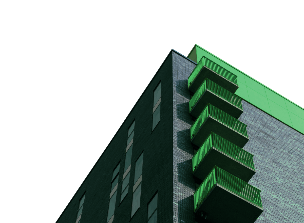 Low-angle view of a modern building corner with green balconies and windows.