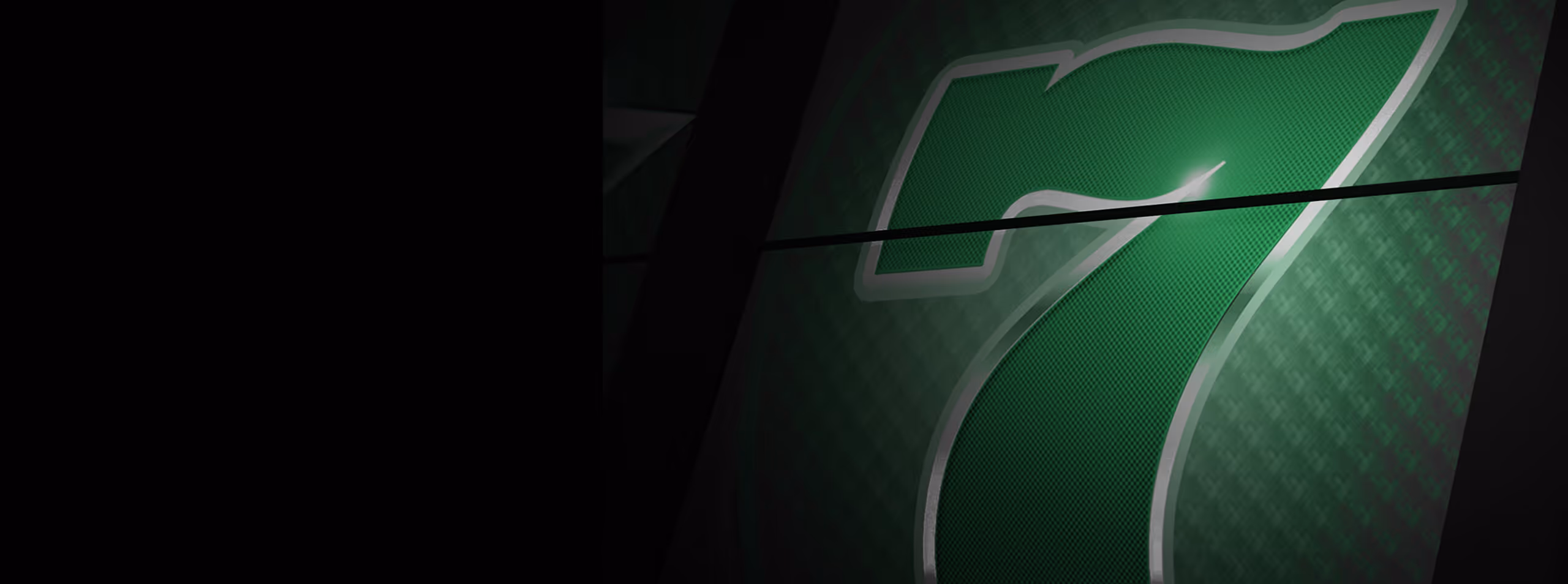 Close-up of a large illuminated green number 7 with a textured pattern on a dark background.