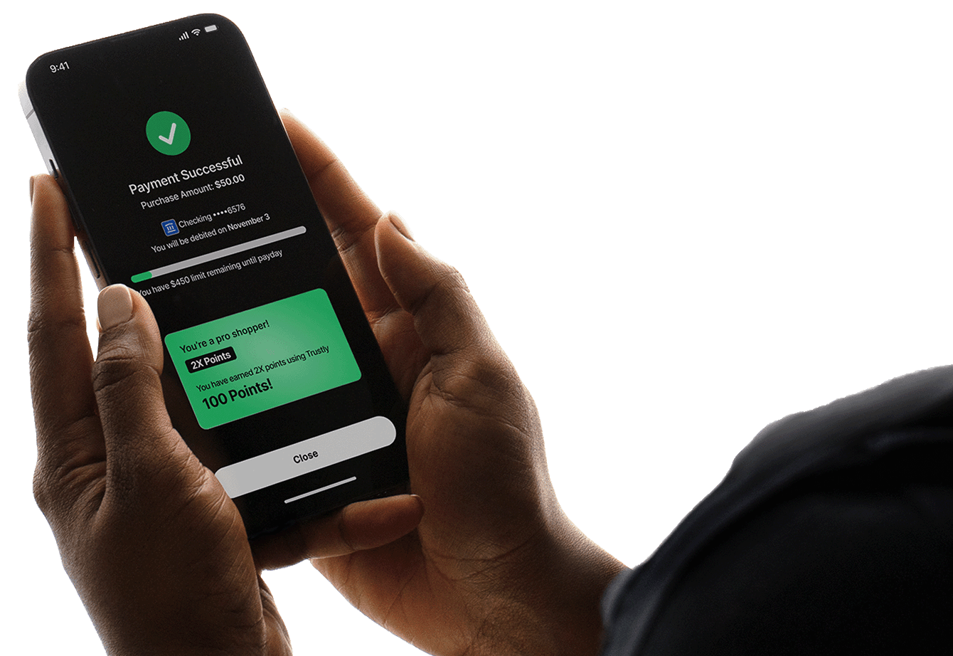 Hand holding a smartphone displaying a payment confirmation screen with a green checkmark, showing a $50 payment success and 100 loyalty points earned.