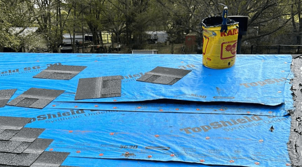 Roofer repairing damaged shingles on a Gainesville, FL home