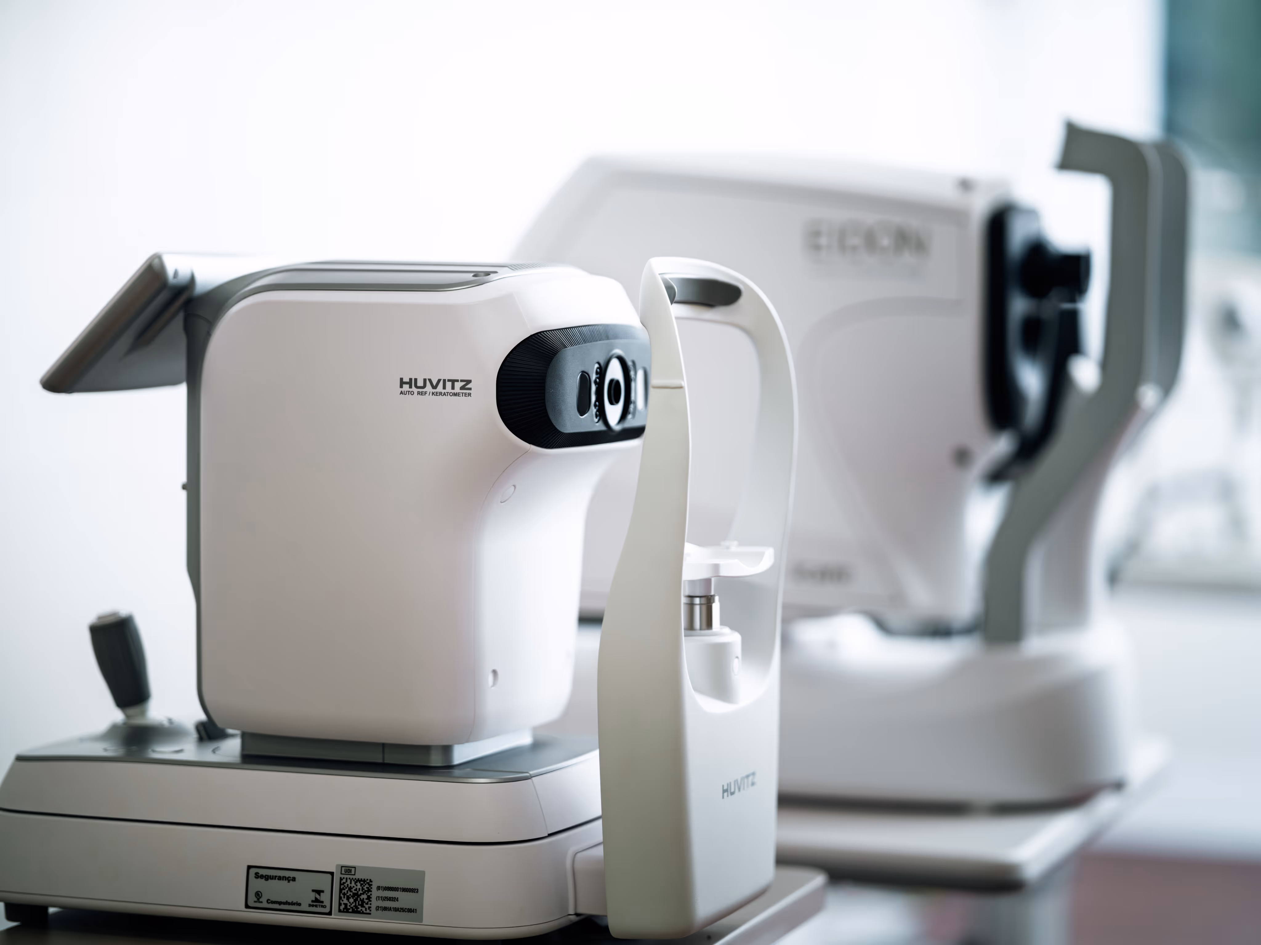 Close-up of Huvitz auto refractor keratometer medical device for eye examinations in a clinical setting.