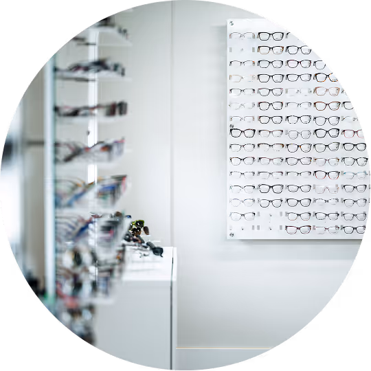 Display wall with multiple pairs of eyeglasses in an optical store.