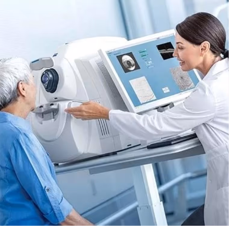 Optometrist conducting an eye scan on an elderly patient using advanced eye examination equipment.