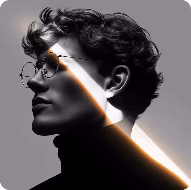 Black and white profile portrait of a young man with curly hair and round glasses, illuminated by a diagonal streak of light.