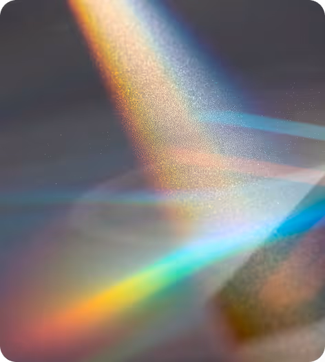 Abstract image of multicolored light beams and reflections on a dark surface.