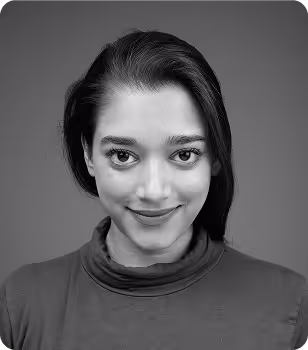 Black and white portrait of a woman with dark hair, wearing a high-neck top, smiling slightly.