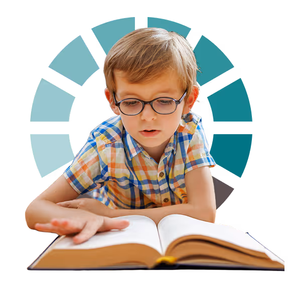 A young boy with glasses intently reading a book, representing literacy foundations coaching for struggling readers and children with dyslexia.