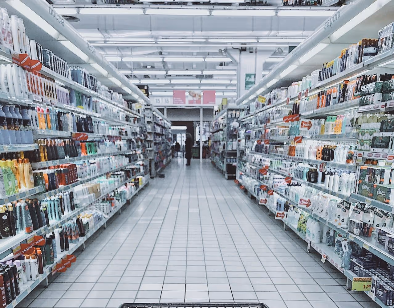 A grocery store aisle lit up by bright white light
