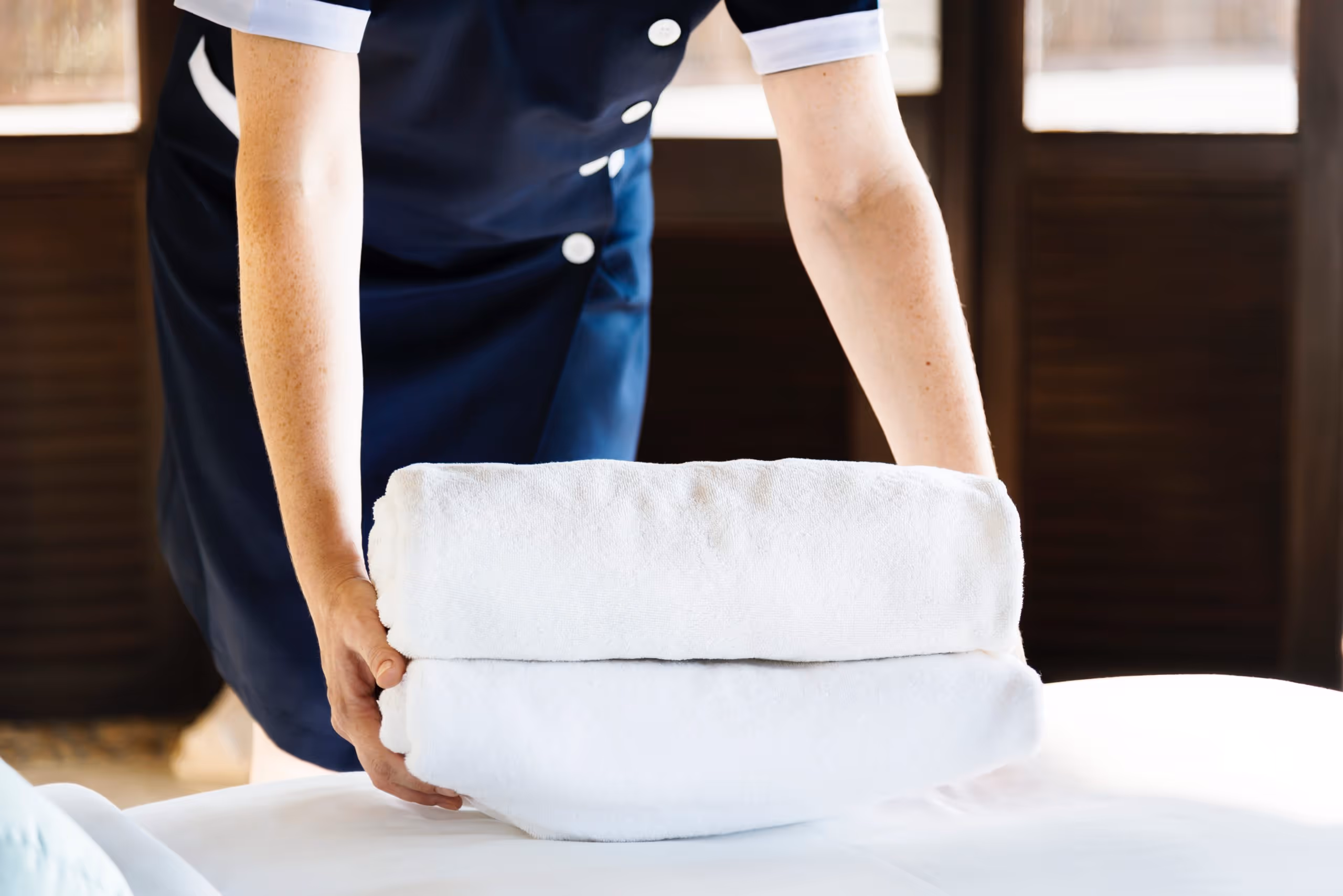 hotel staff folding towels and bedding