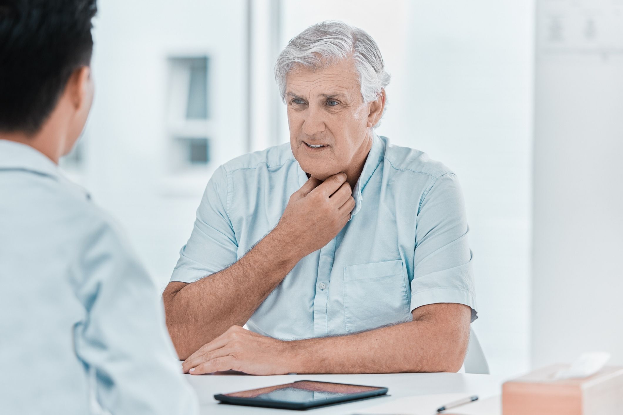 Worker consulting doctor after diagnosis, representing asbestos esophageal cancer cases.