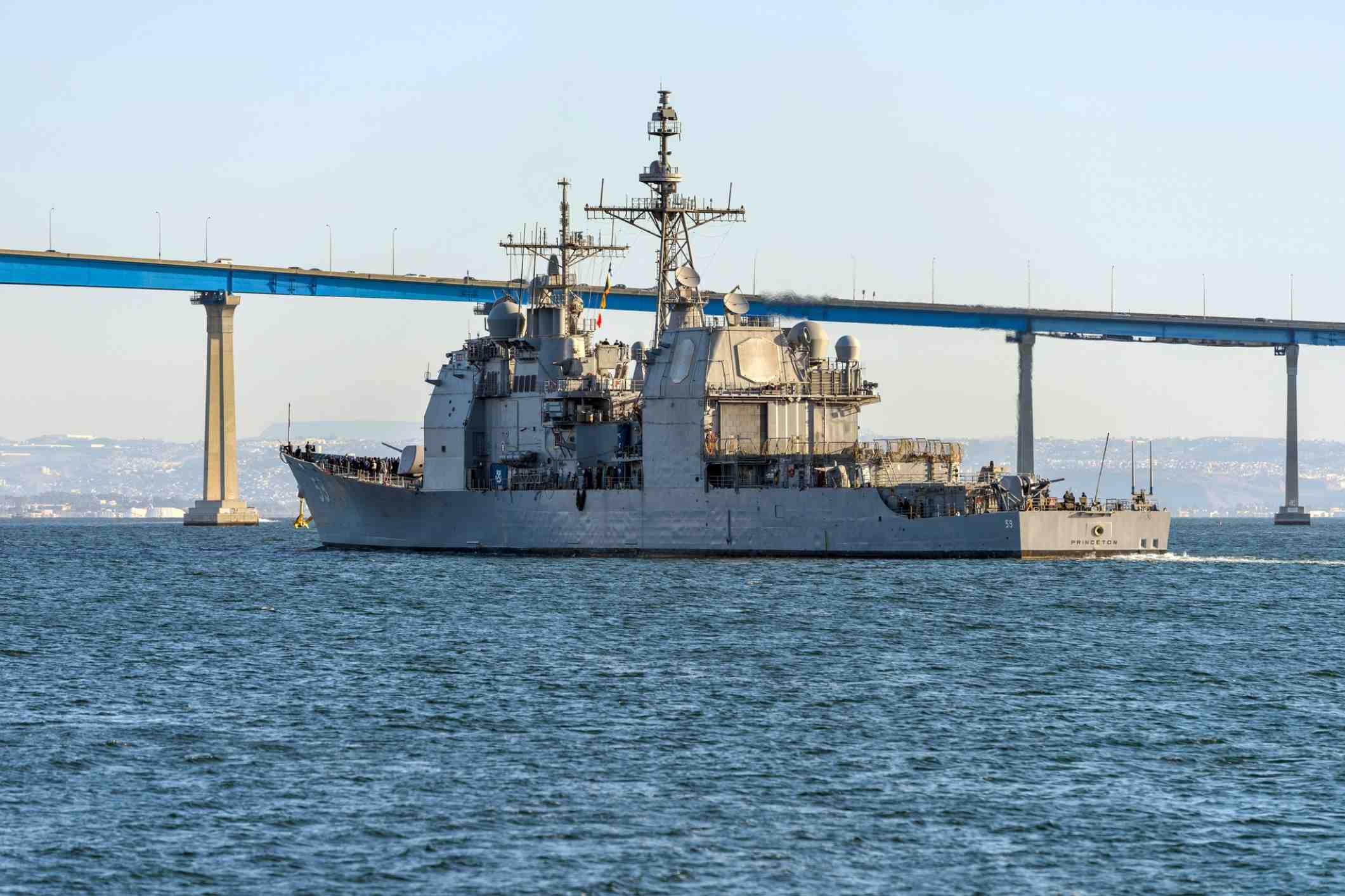 Navy vessel under Coronado Bridge, representing asbestos exposure at Naval Base San Diego.
