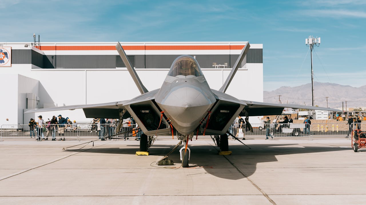 A fighter jet outside a hanger at an air force base