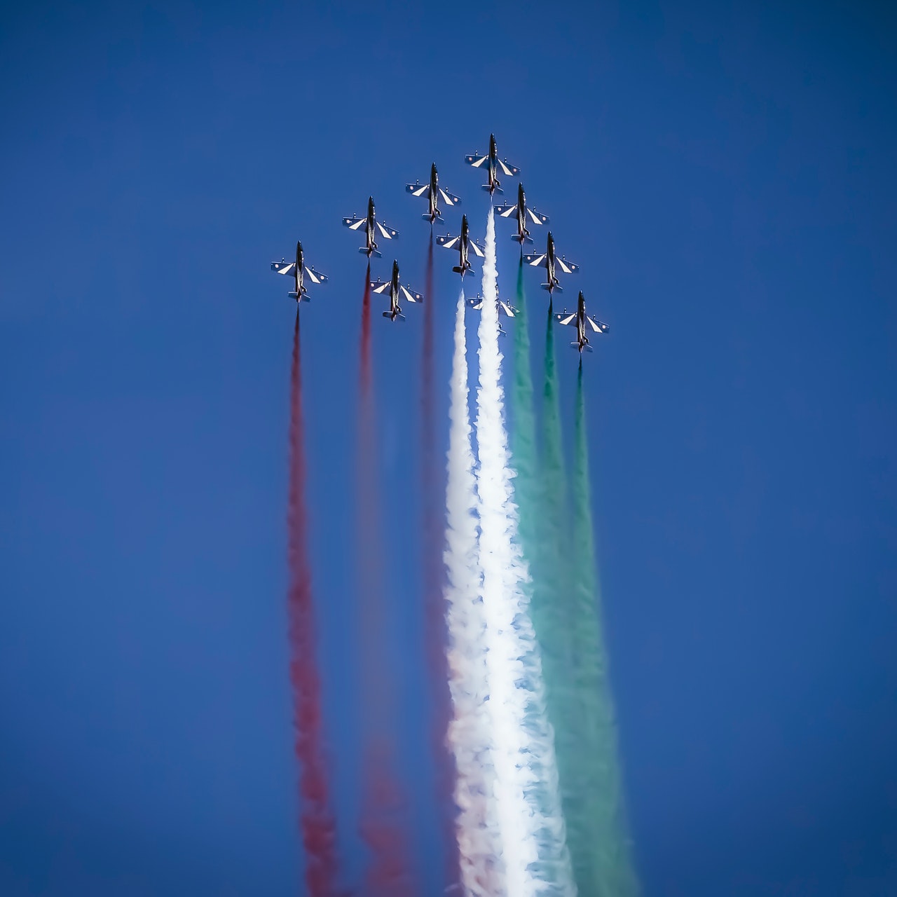 ten fighter jets flying in formation at an air show above an air force base