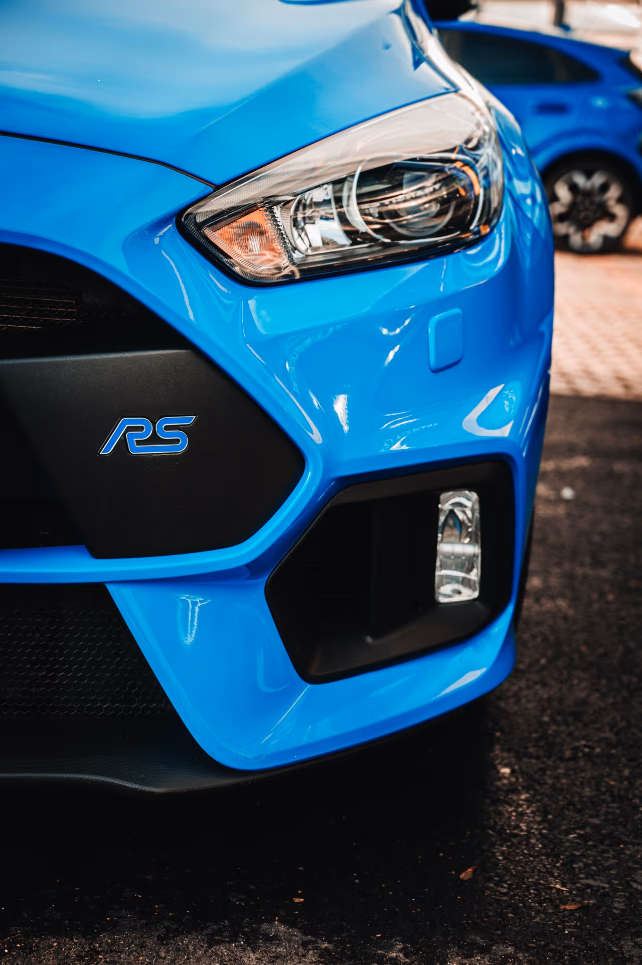 headlight and front fender on a candy blue car