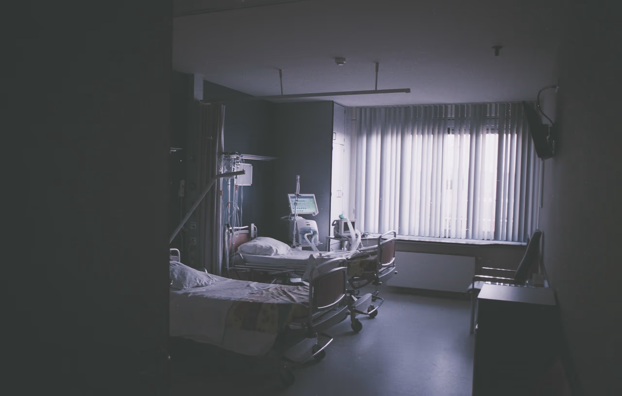 dark hospital room with two beds