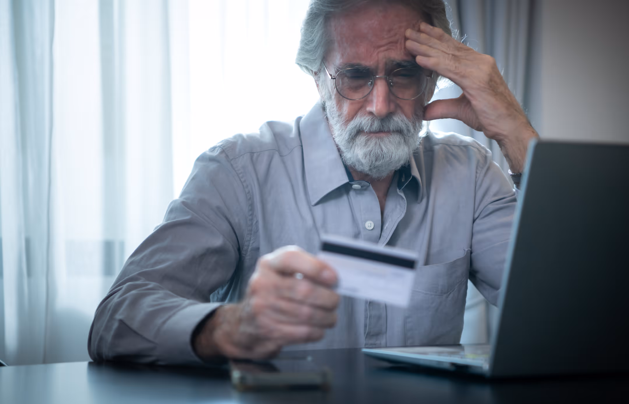 A man using a credit card to pay for something online