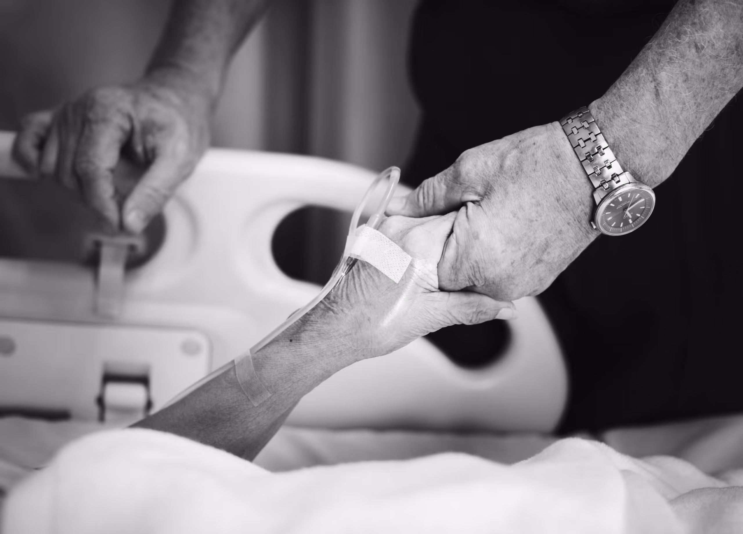 a woman holding a patient's hand in the hospital