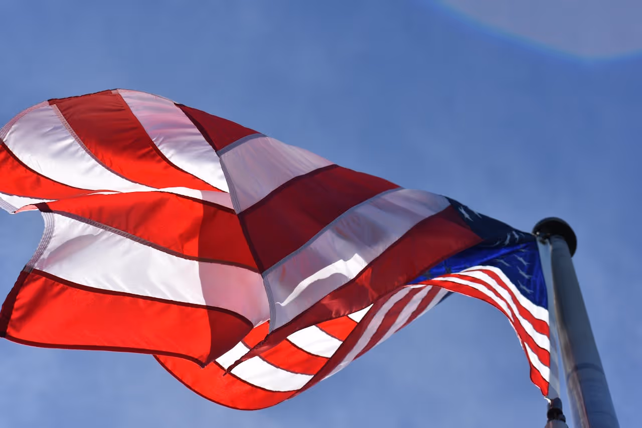 American flag on a flagpole flying in the wind