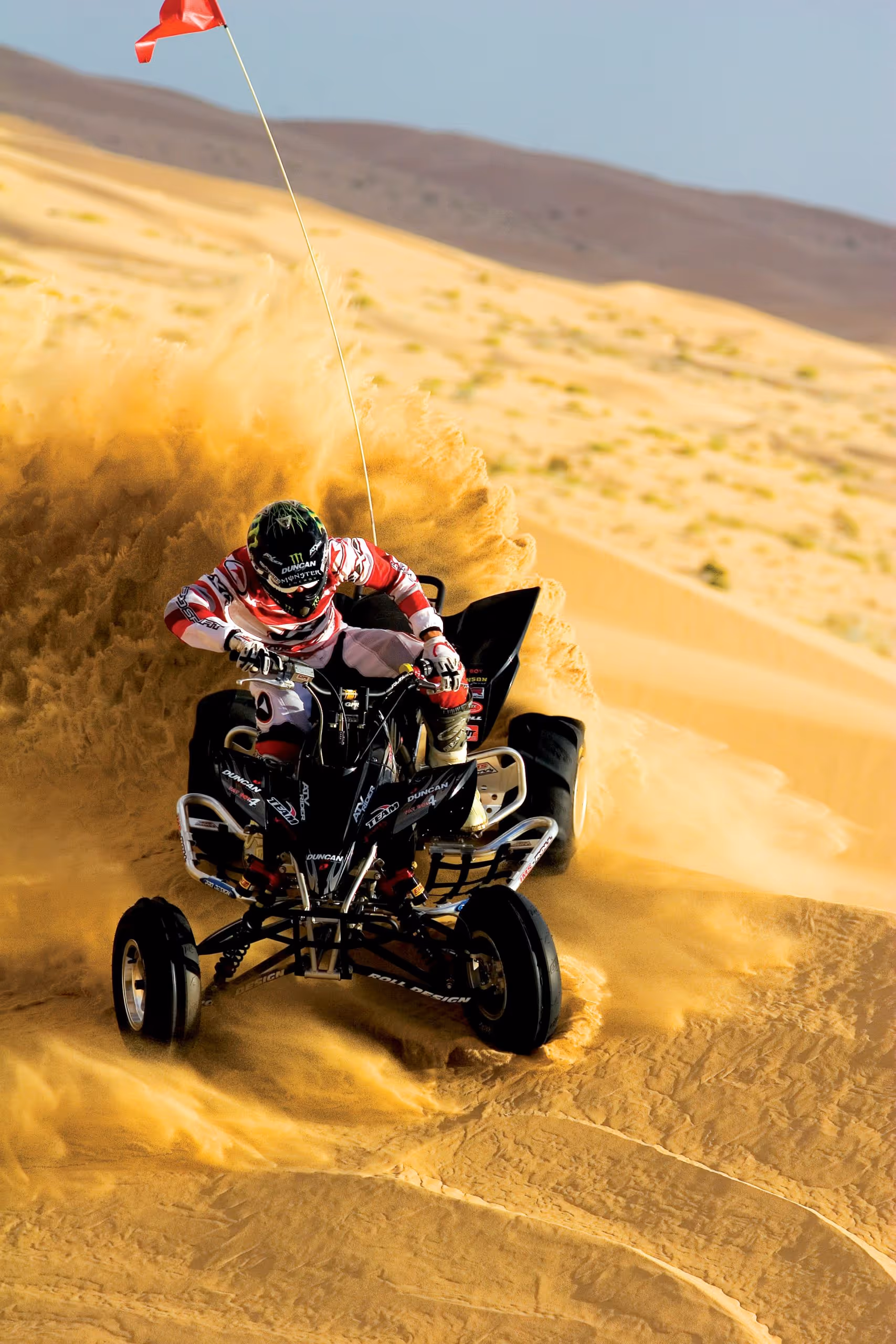 man driving atv on sand