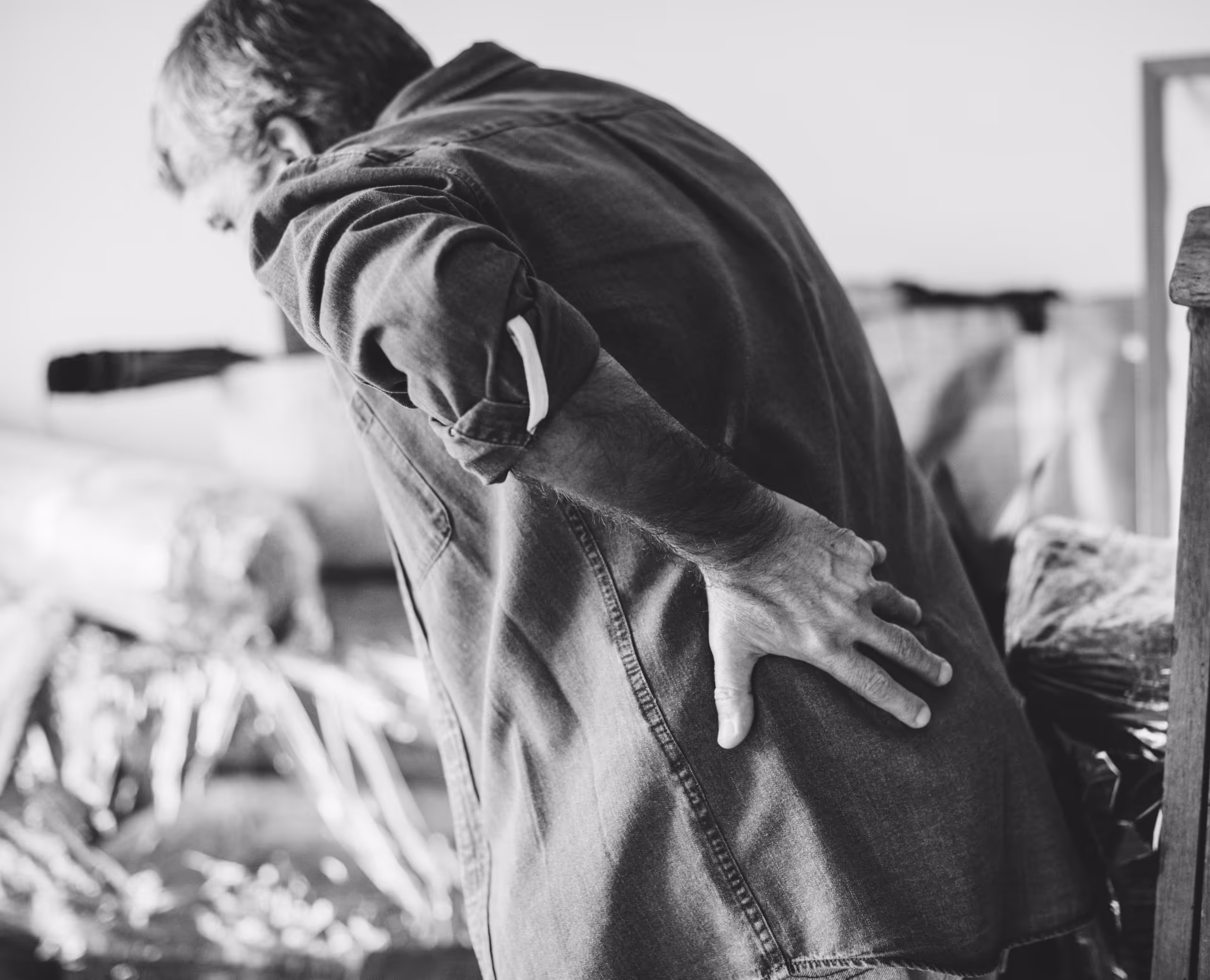 man holding his back in pain