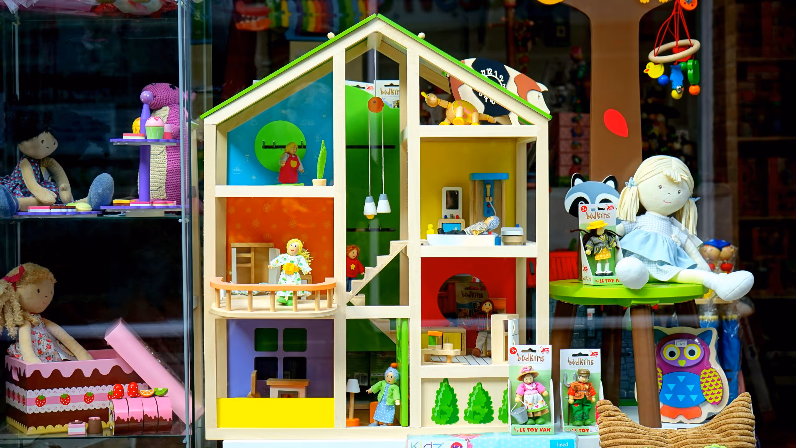 Figurines, playhouse and other toys in storefront window