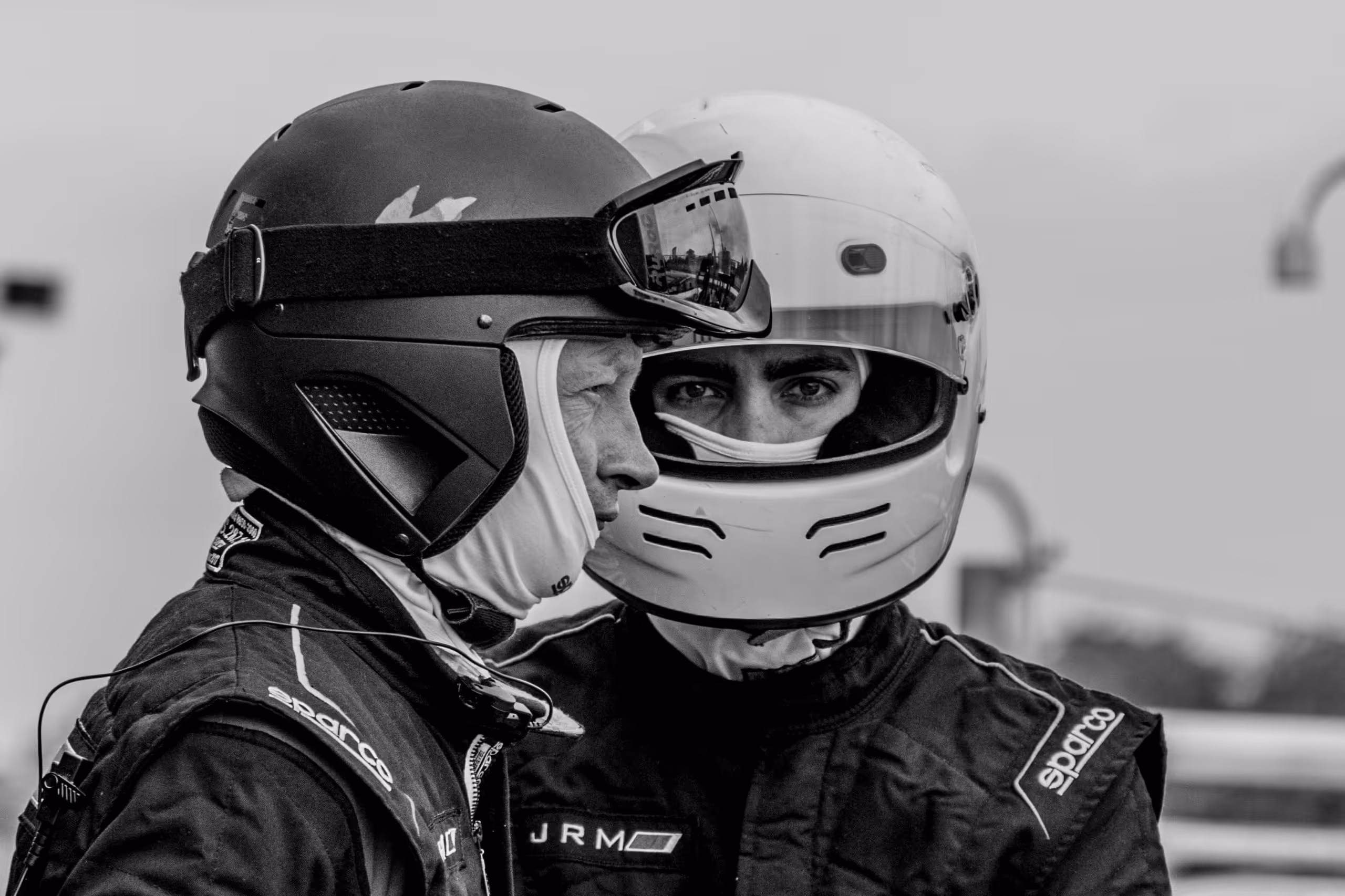 two people in motorcycle helmets