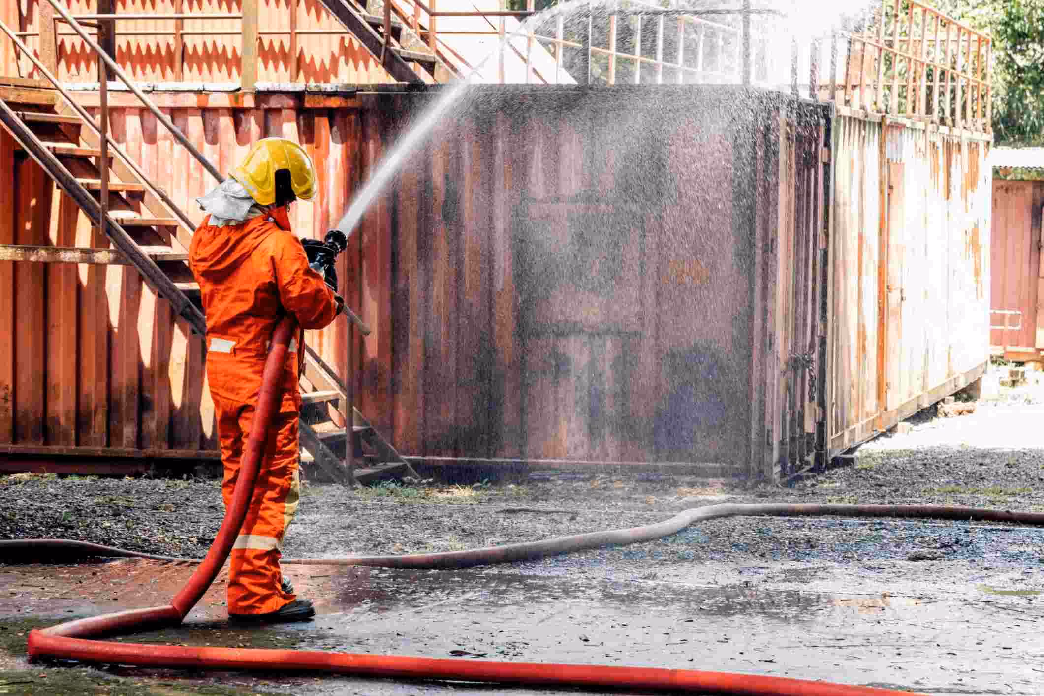 A man using firefighting foam, a key component in a PFAS water contamination lawsuit.