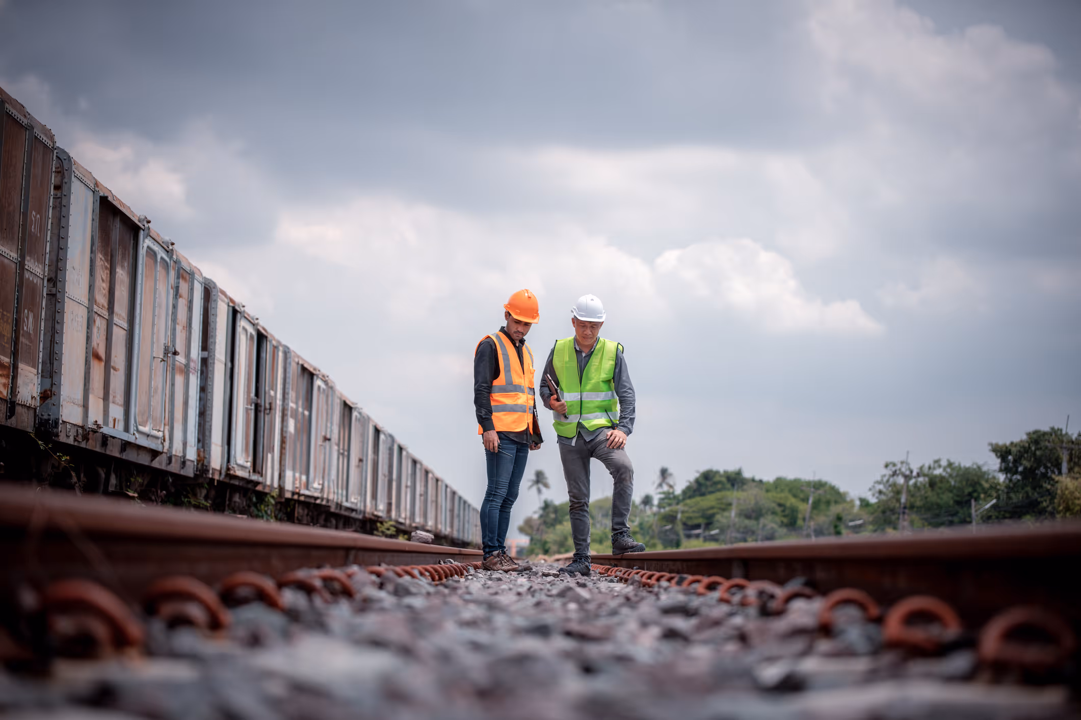 Two railroad workers stand next to each other. They might be eligible for a FELA claim if they were injured at work.