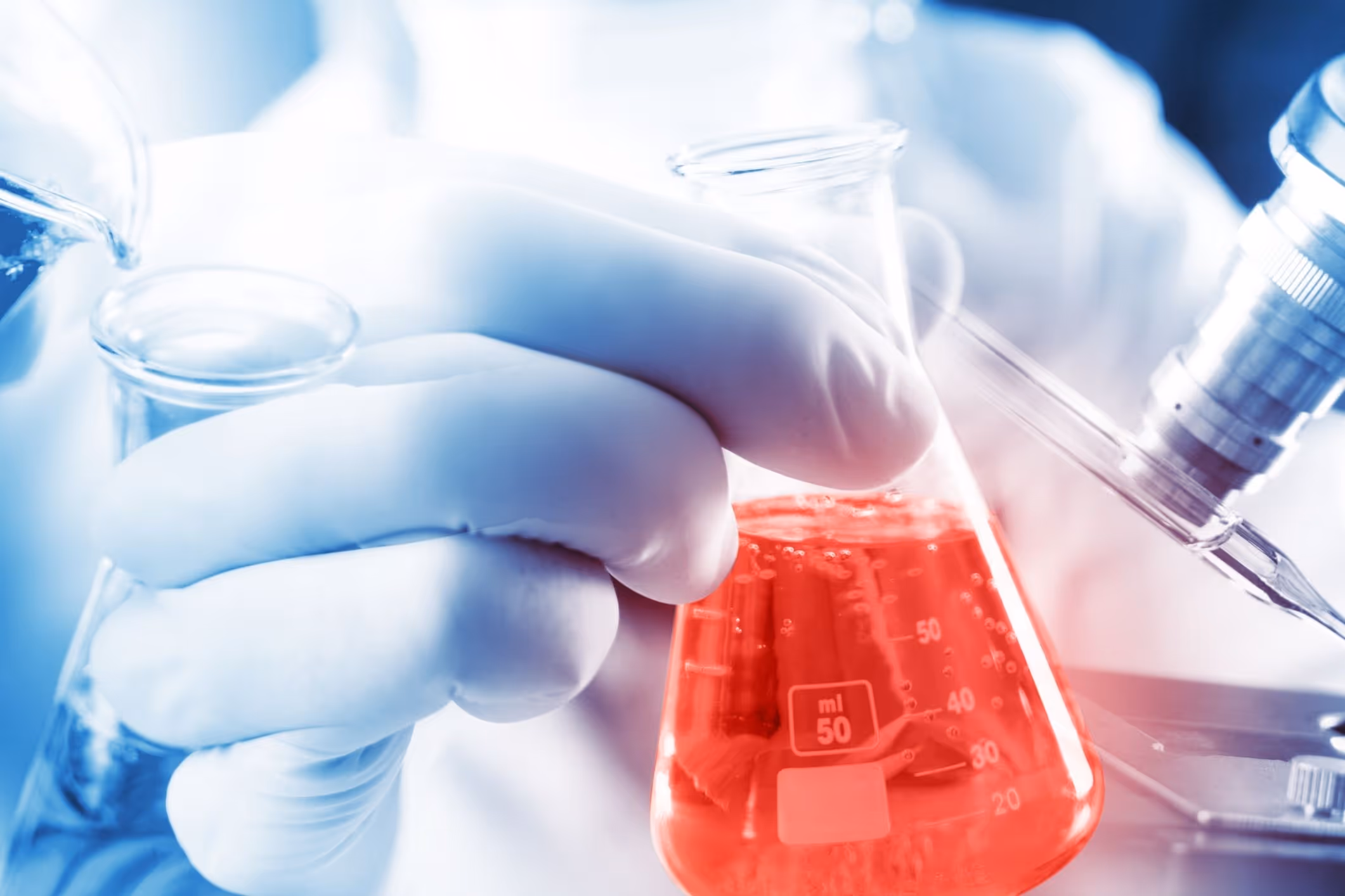 Person handling lab chemicals, symbolizing the risks of occupational benzene exposure and its links to blood cancers like AML and MDS.
