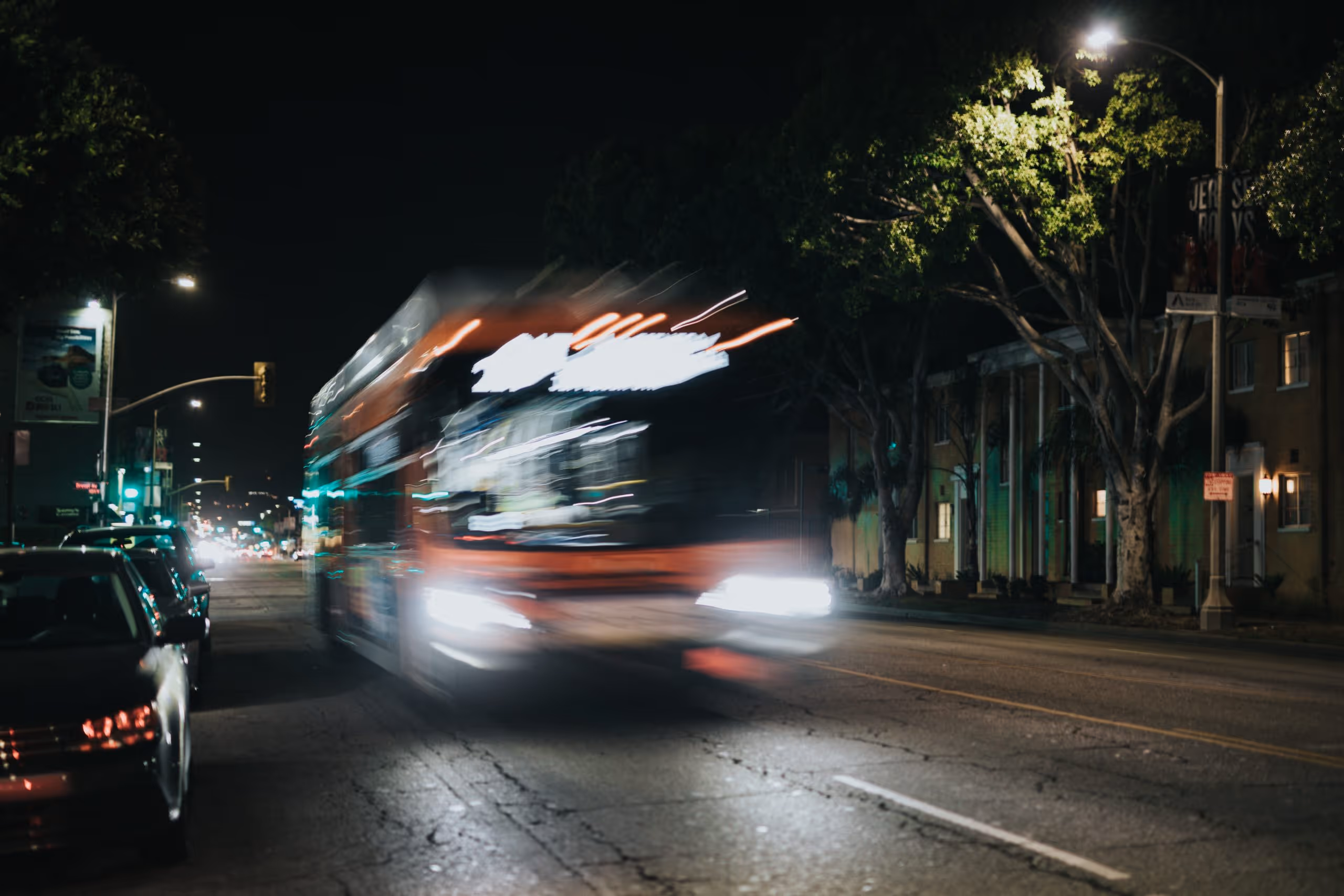 A city bus driving at night