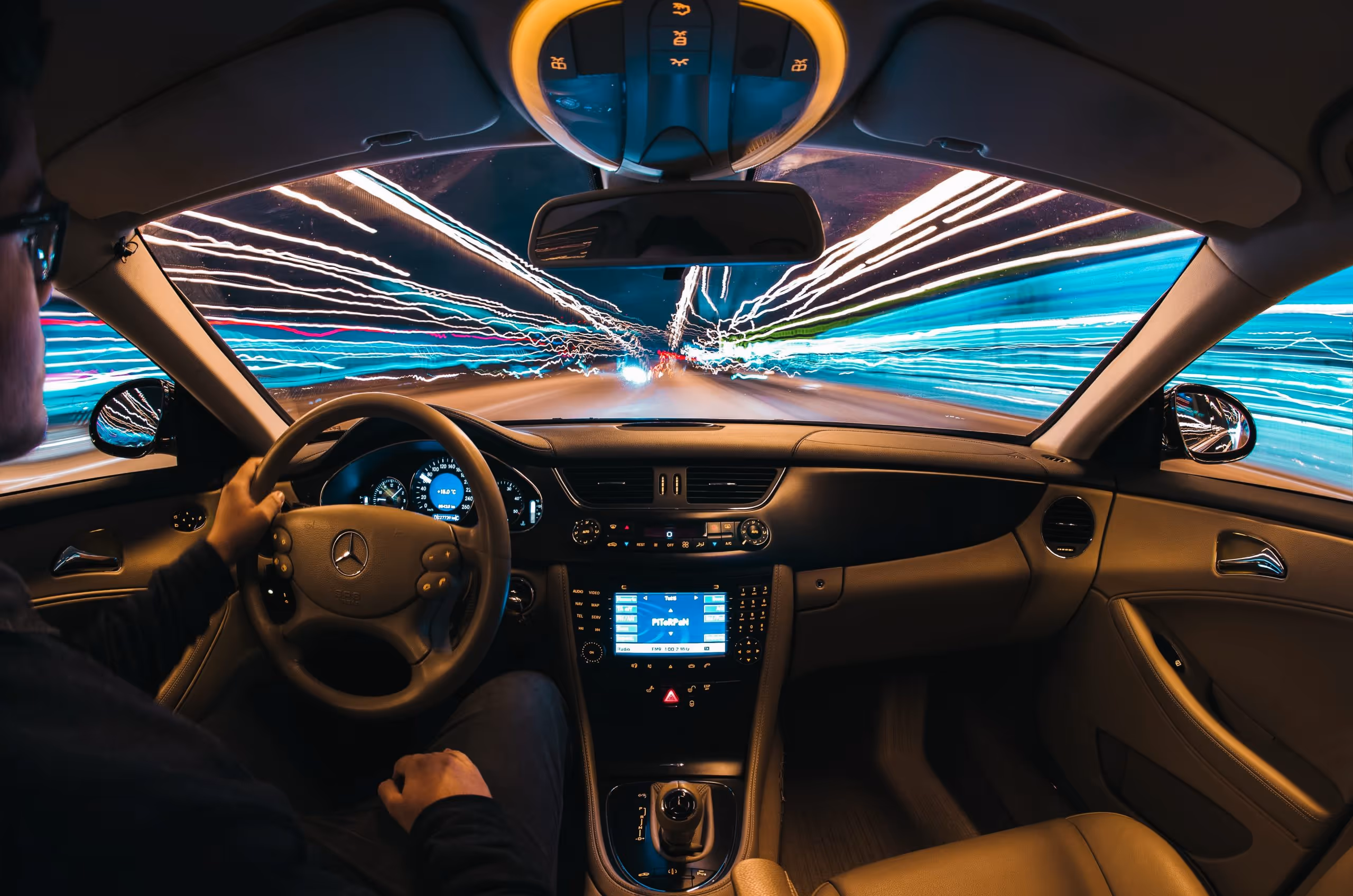 a car driving through a blurry night, simulating drunk driving