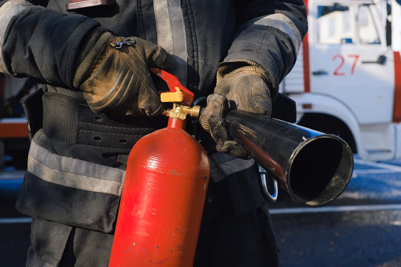 photo of fire fighter holding fire extinguisher