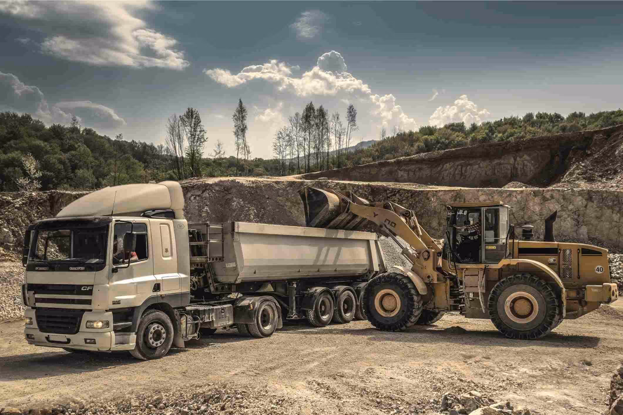 heavy machinery like a front loader and truck at mining site
