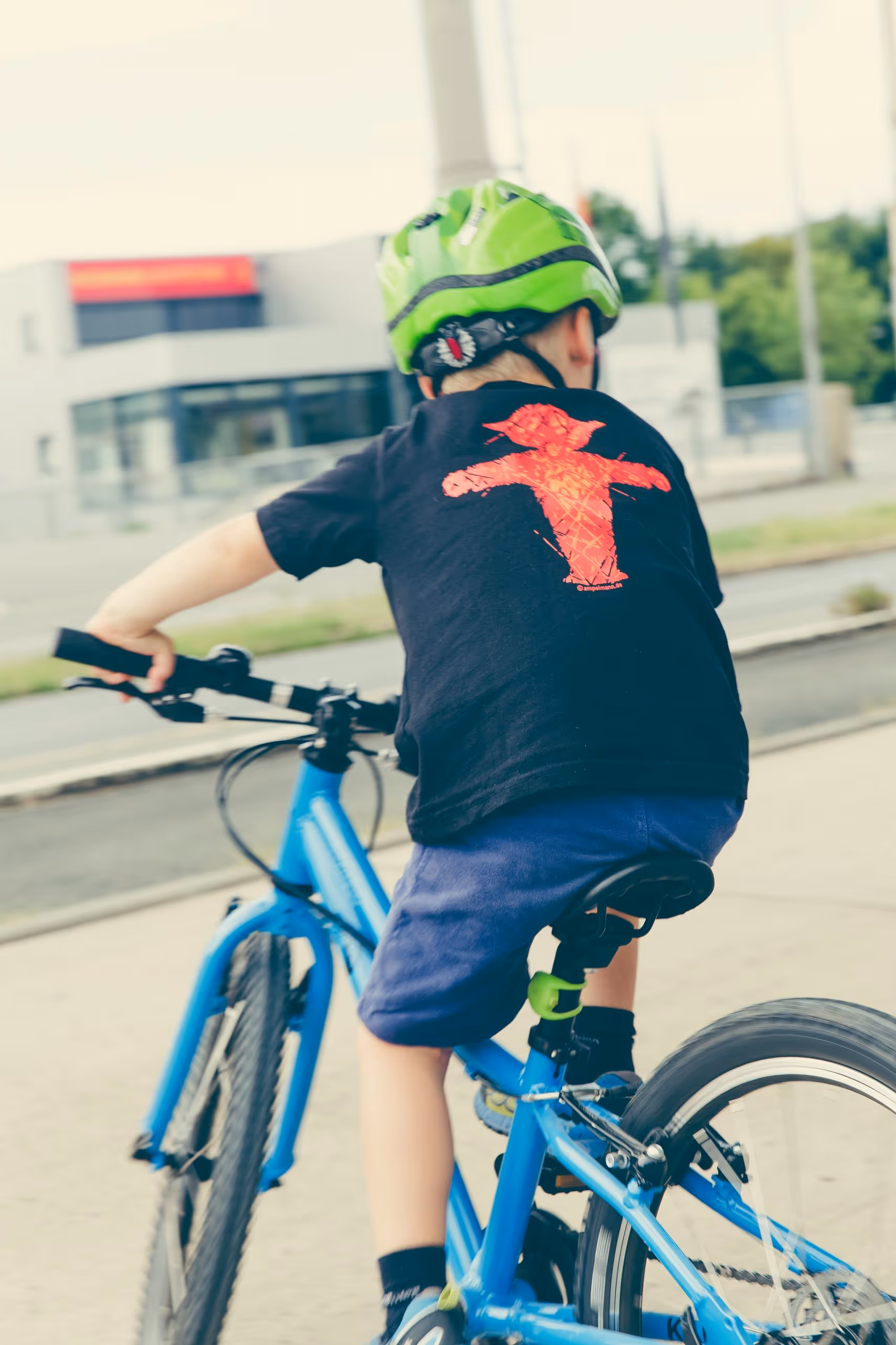 child wearing helmet on bike