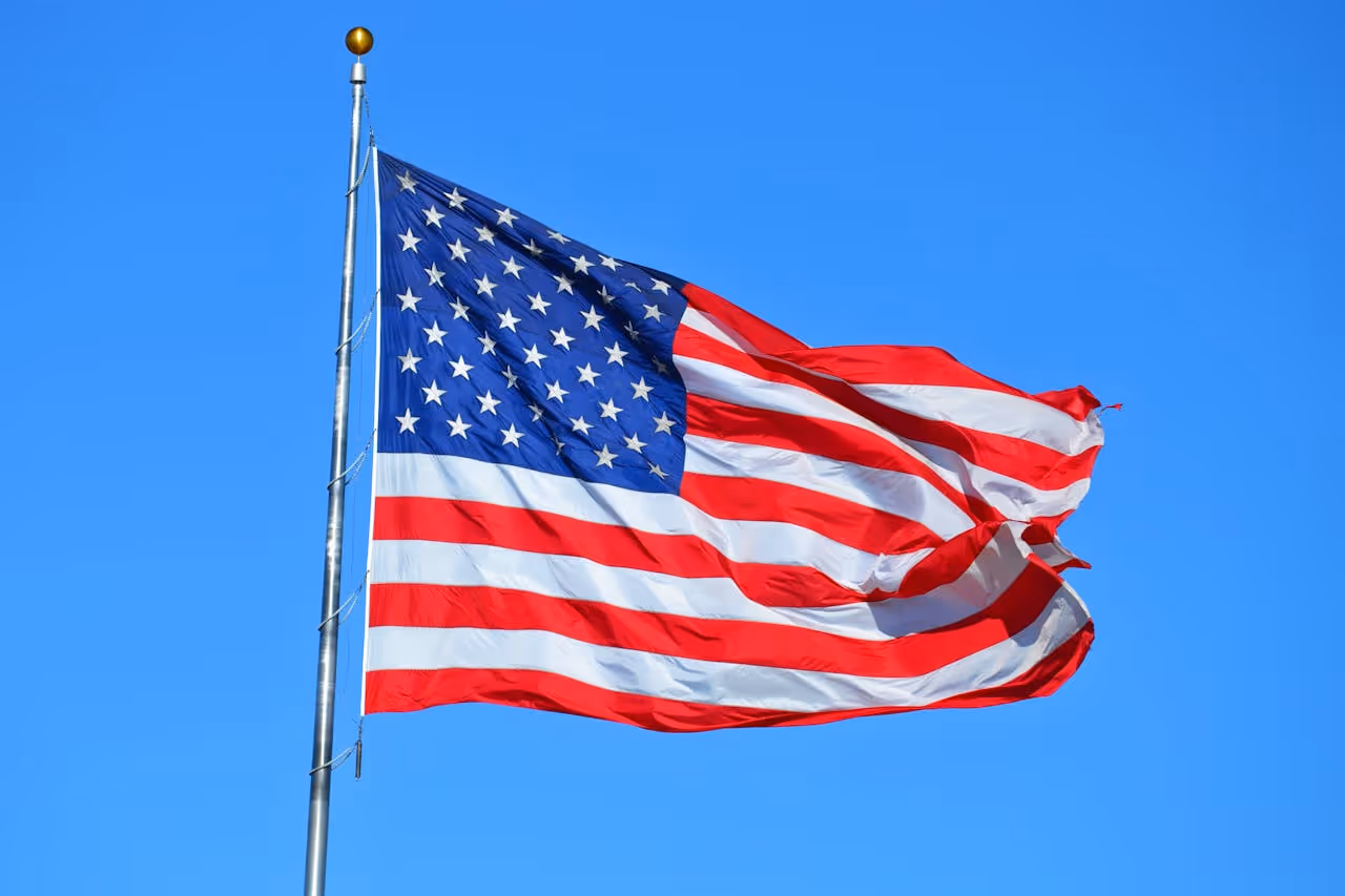 American flag fling in the wind on a clear day