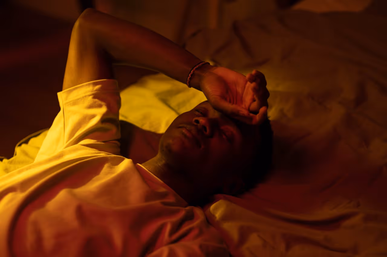 Man in bed struggling to sleep