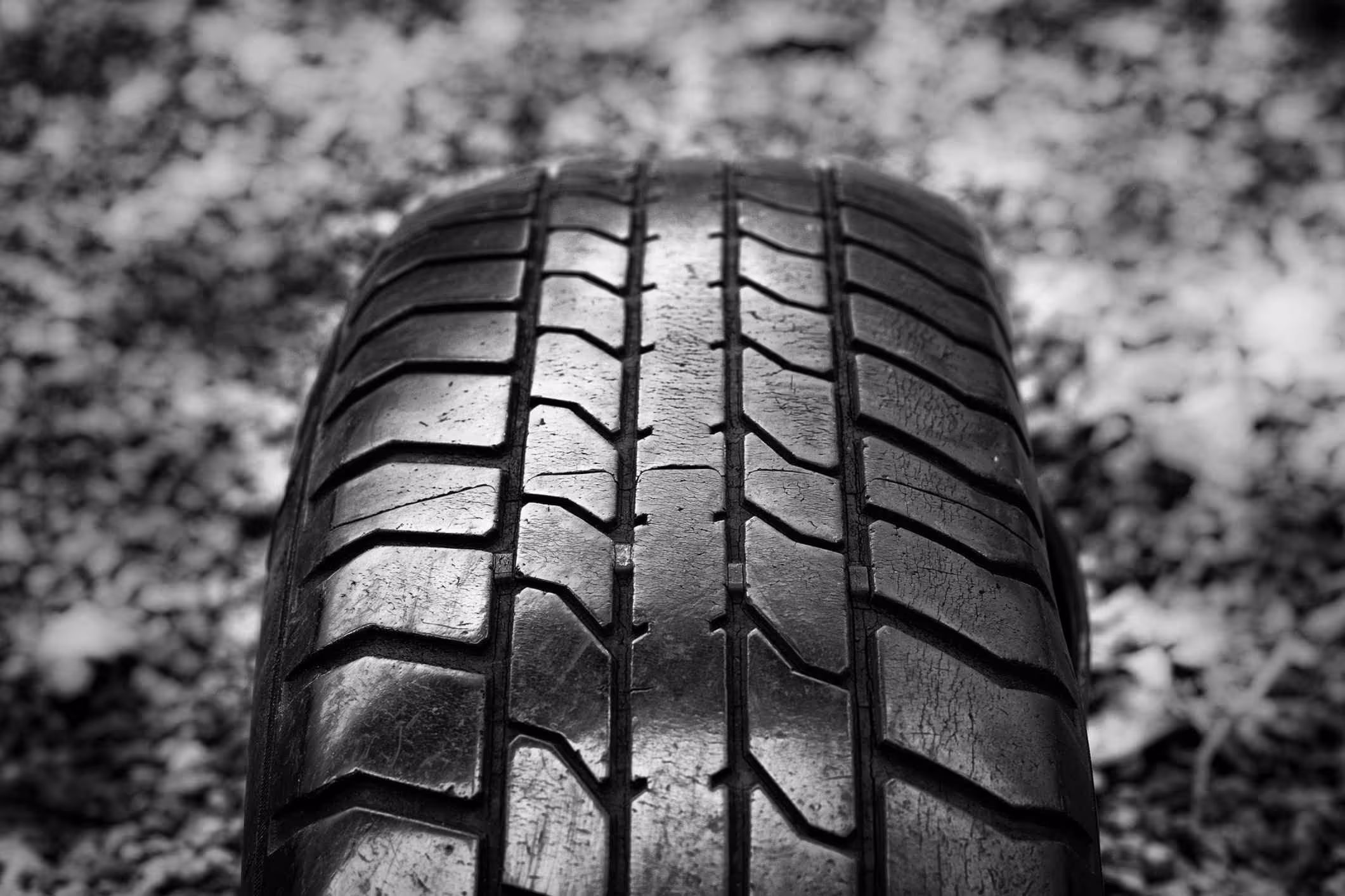 car tire shown with cracks in the treads