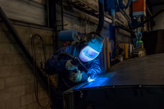 a welder working in an industrial setting
