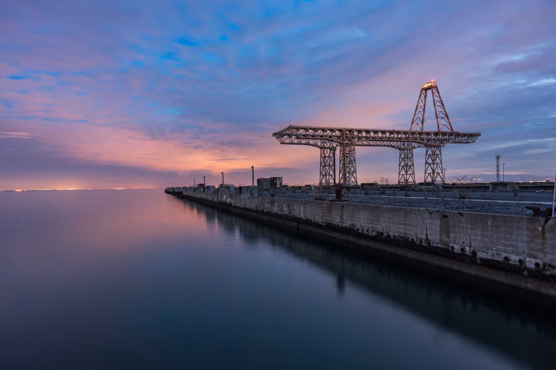 A crane and heavy equipment at an industrial port