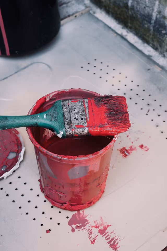 a bucket of paint and paintbrush
