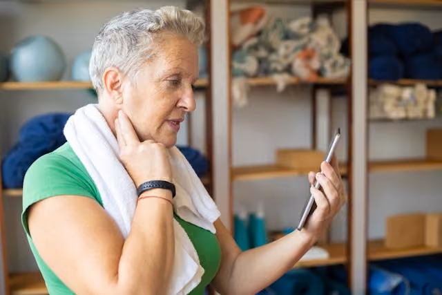 An older woman looking at her cell phone