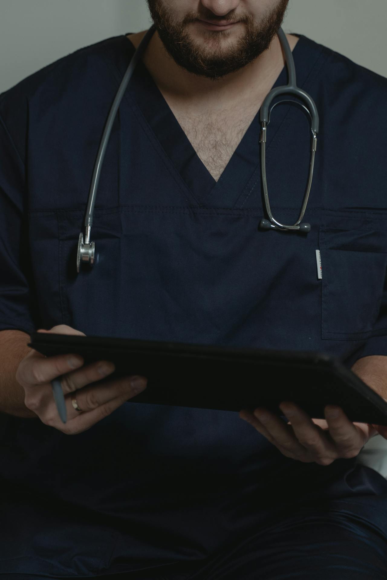A healthcare worker uses a tablet at work