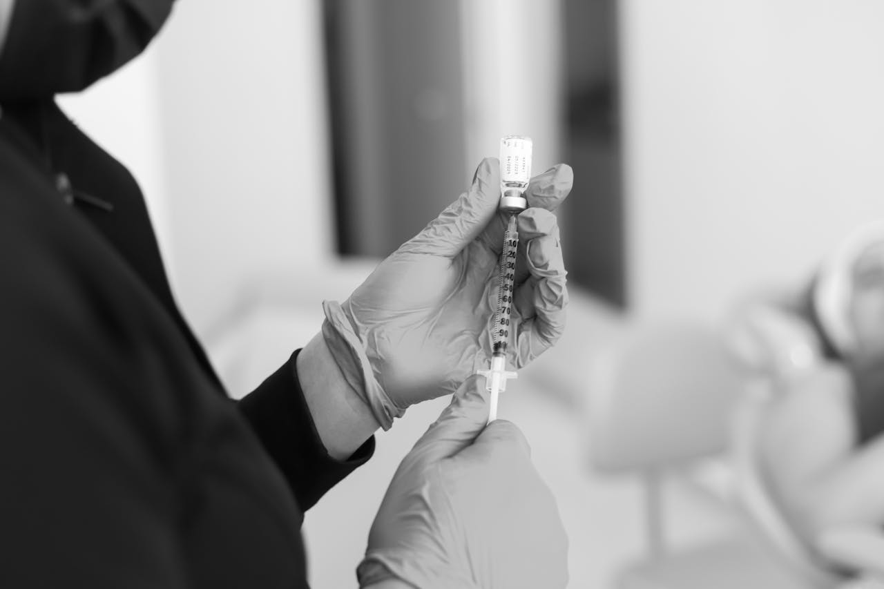 A botox injection is seen being prepares with a syringe and bottle of solution
